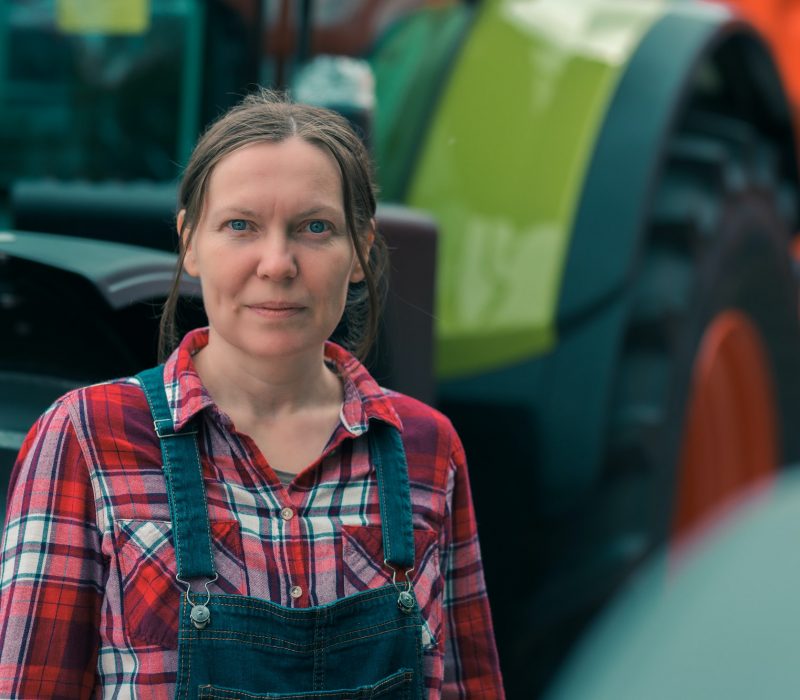 Female farmer and agricultural tractor